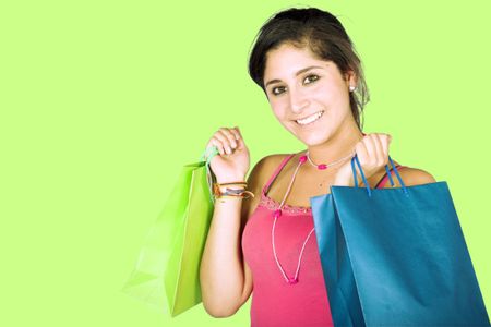 girl with shopping bags over green background
