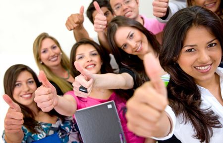 group of students smiling and doing a thumbs up sign