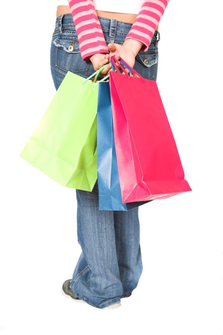girl in jeans with shopping bags over white