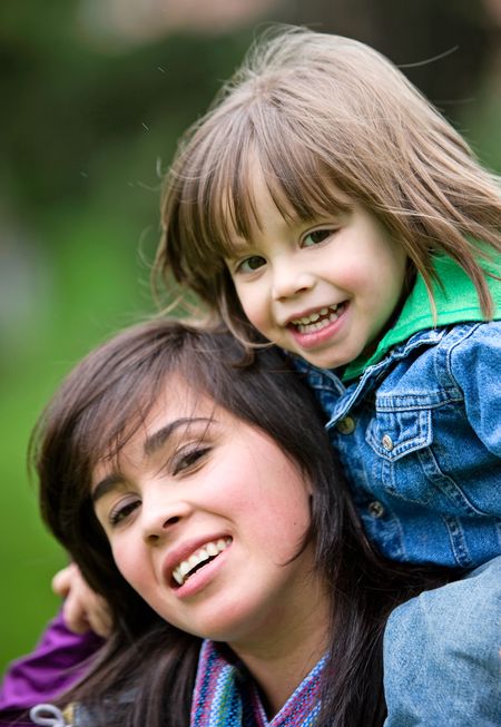 family lifestyle portrait of a mother with her son having fun outdoors