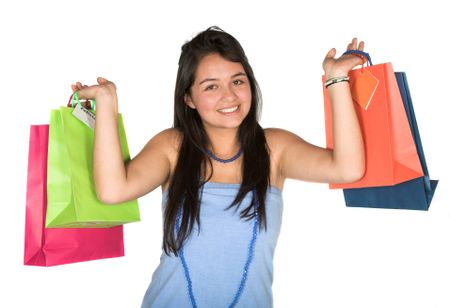 beautiful teenager with shopping bags over white