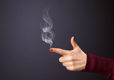 Gun shaped woman hand with smoke | Freestock photos