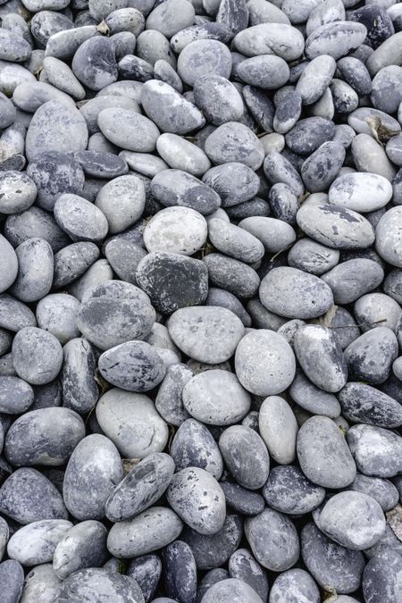 Background of smooth rounded stones outdoors