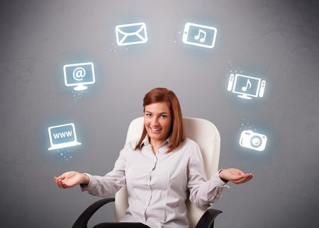 pretty girl sitting and juggling with elecrtonic devices icons