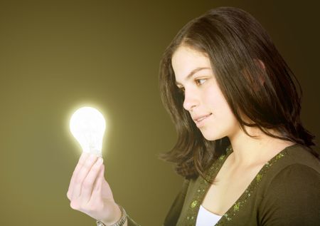 creative girl with a light bulb over a green background