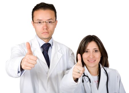 couple of doctors with a positive attitude - thumbs up over a white background - focus is on the faces