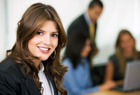 business woman leading a team in an office smiling