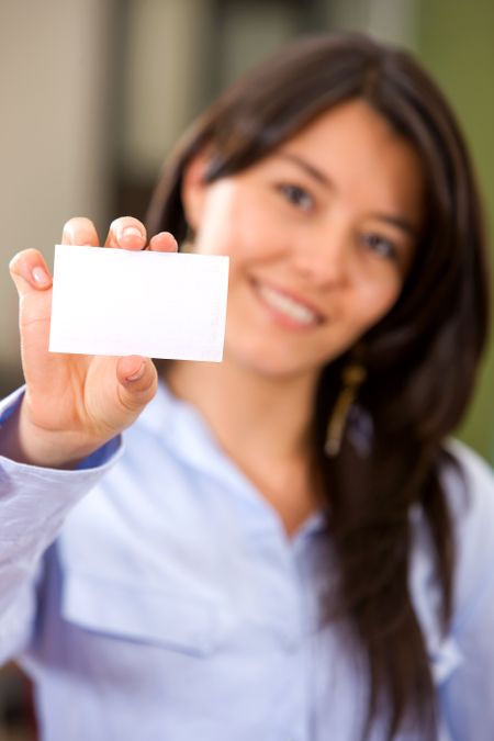 businesswoman displaying a card in an office