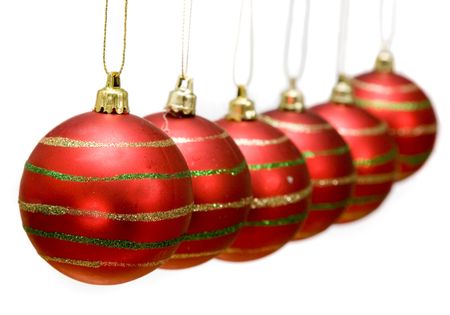 red christmas baubles in a row over a white background
