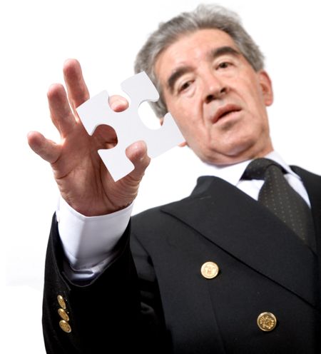 business man holding a puzzle piece on white