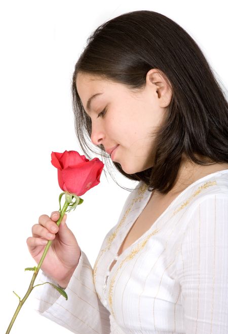 casual girl holding a red rose in a very deep and thoughtful mood - over a white background