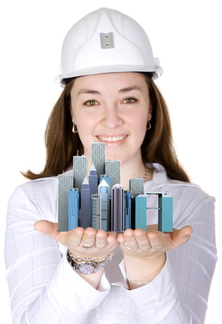 corporate female architect smiling over a white background while holding some business financial buildings in her hands