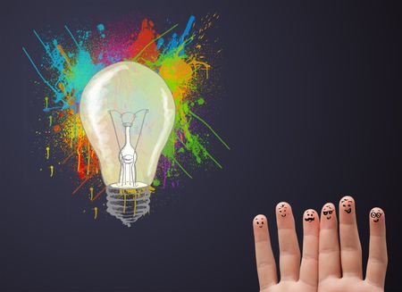 Happy cheerful smiley fingers looking at abstract hand drawn colorful lightbulb