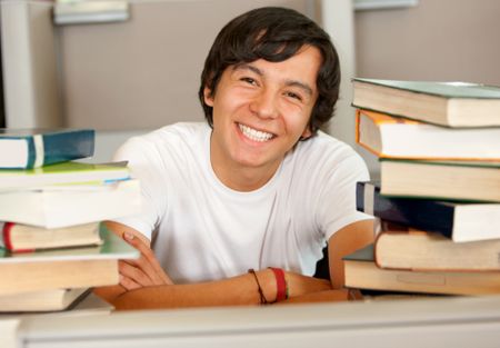 college or university student in a library smiling