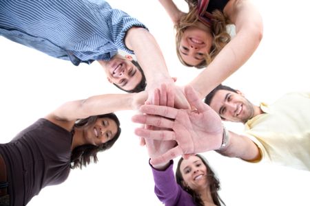 Happy group of friends with their hands together in the middle - isolated