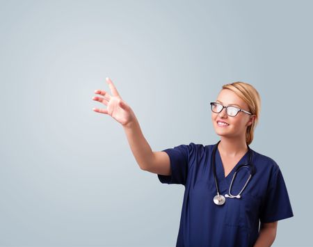 Pretty young female doctor gesturing with copy space
