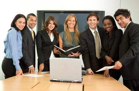 businesspeople around a laptop in a business meeting in an office