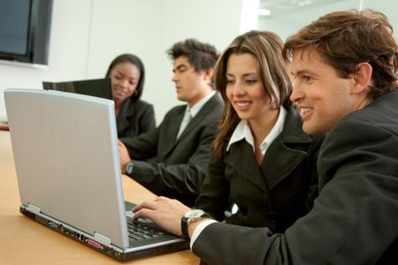 businesspeople in a business meeting in an office smiling