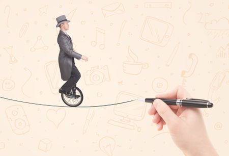 Businessman riding monocycle on a rope drawn by hand concept