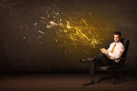 Businessman with tablet and energy explosion on background concept
