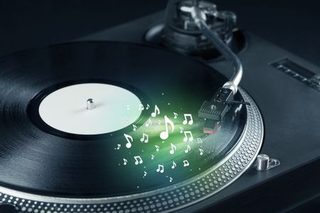 Turntable playing music with audio notes glowing concept on background