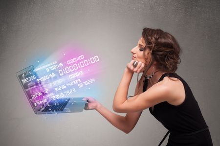 Attractive casual woman holding laptop with exploding data and numers