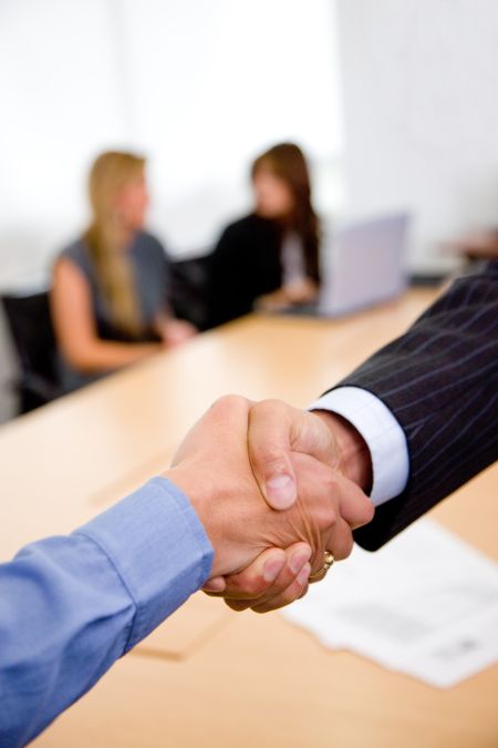 Close up of two business men shaking hands - business concepts