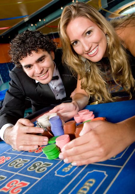 couple at the casino winning on the roulette