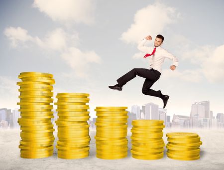 Successful business man jumping up on gold coin money concept