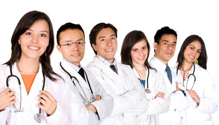 friendly young doctors smiling over a white background - focus is on the female doctor on the left