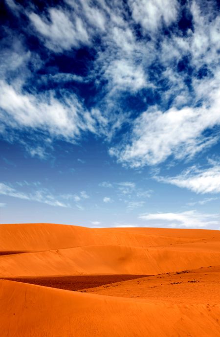 sand dunes landscape with a blue sky on a beautiful day