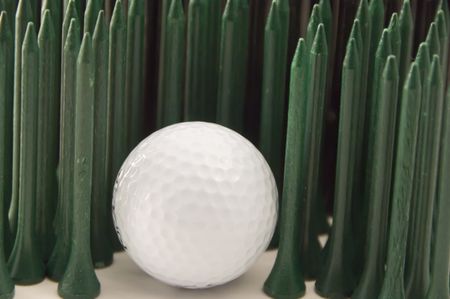 Golf ball in a forest of green tees