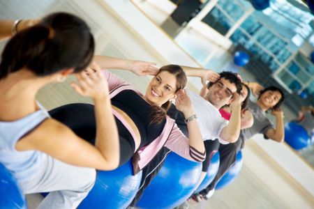 Group of people at the gym doing pilates
