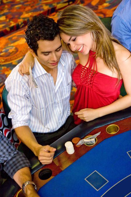 Loving couple at the casino gambling and smiling