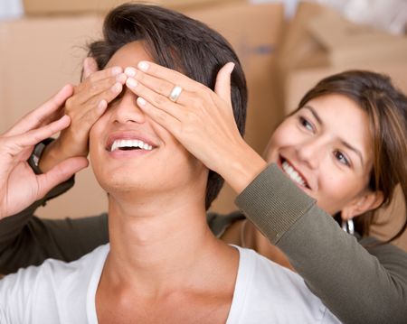 Woman covering the eyes of her removal partner