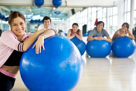 Group of people with pilates ball smiling