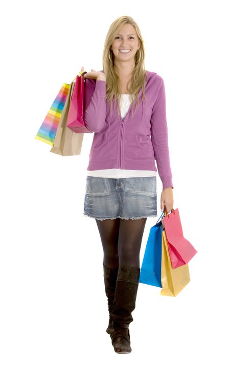 Casual woman walking with shopping bags isolated over white
