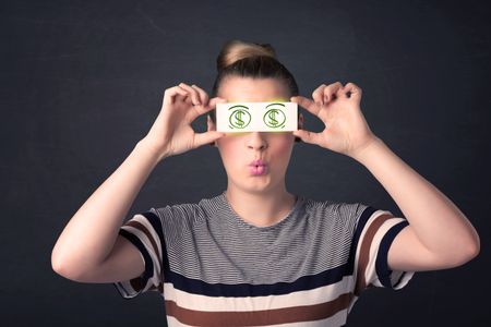Young girl holding paper with green dollar sign concept