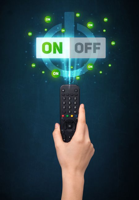 Hand holding a remote control, on-off signal coming out of it
