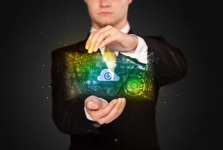Businessman holding a shining data cloud in front of his body
