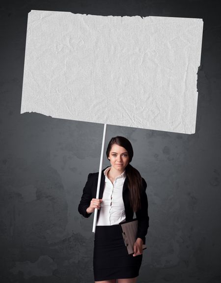 Young businesswoman holding a big blank booklet paper
