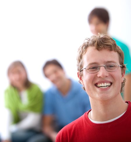 Young man smiling and some friends behind him