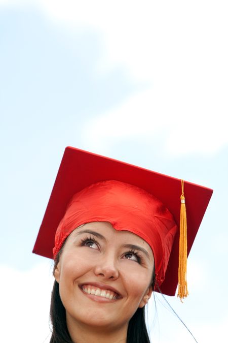 Portrait of a female graduate looking at the sky
