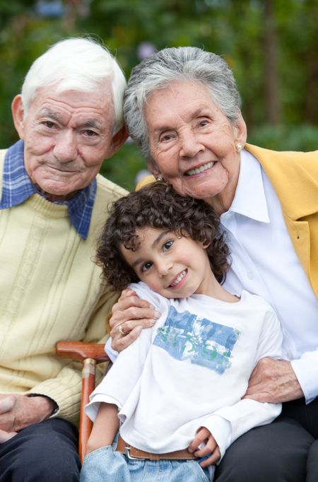 Portrait of a child with his grandparents outdoors