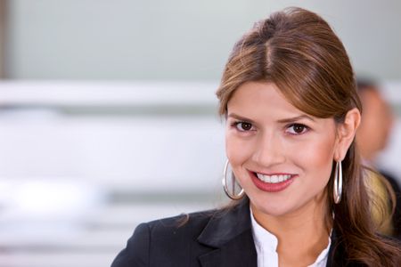 business woman portrait in an office smiling