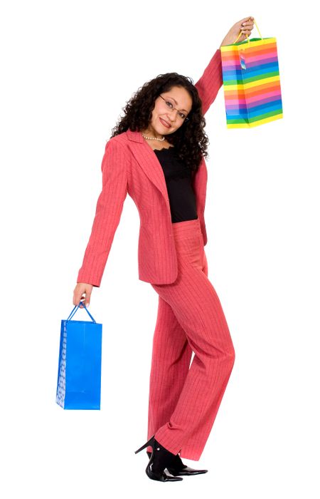 business woman in pink looking very happy with her shopping bags over a white background