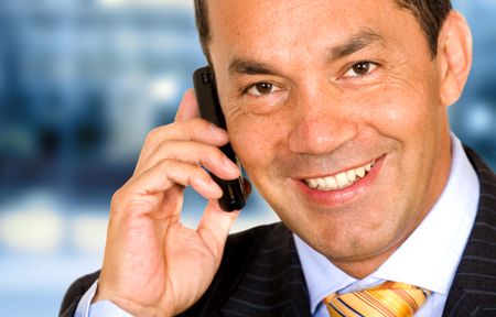 Business man on the phone in an office over a blue background