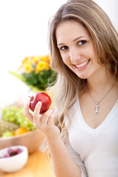 beautiful casual woman holding a red apple