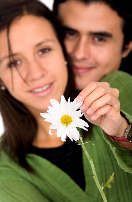 cute couple with a white flower smiling at the camera
