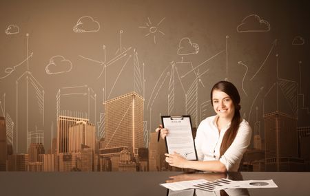 Businesswoman sitting at the black table with buildings and measurements on the background
